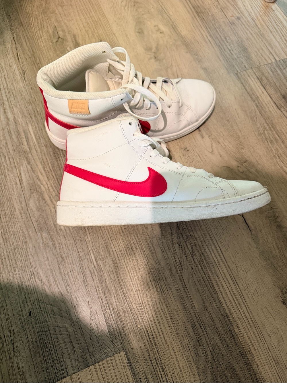 Nike White High-Top Sneakers with Pink Swoosh
